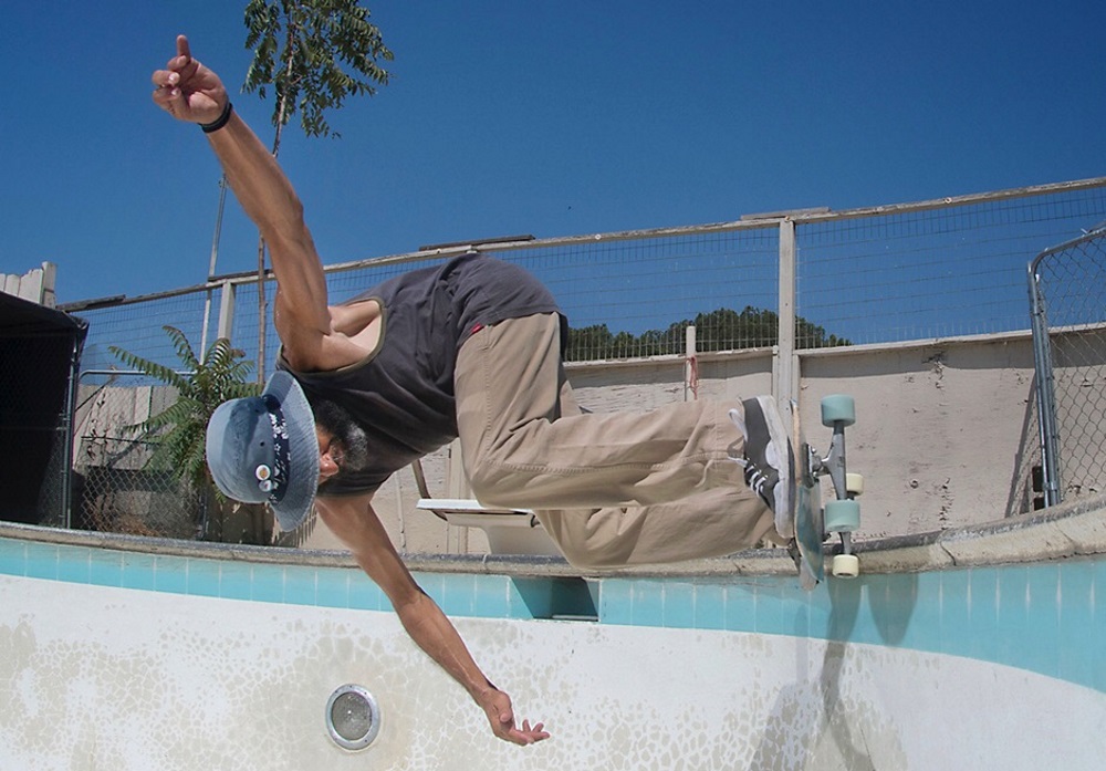 Tony Alva skating a pool at age 60