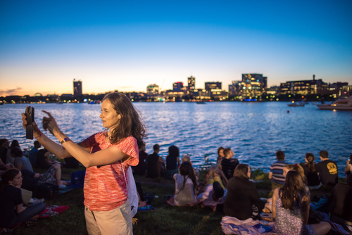 Woman taking a selfie in front of Boston Harbor