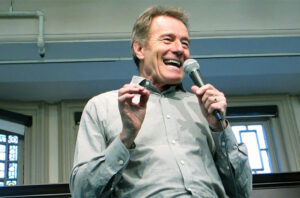Bryan Cranston speaking into a microphone