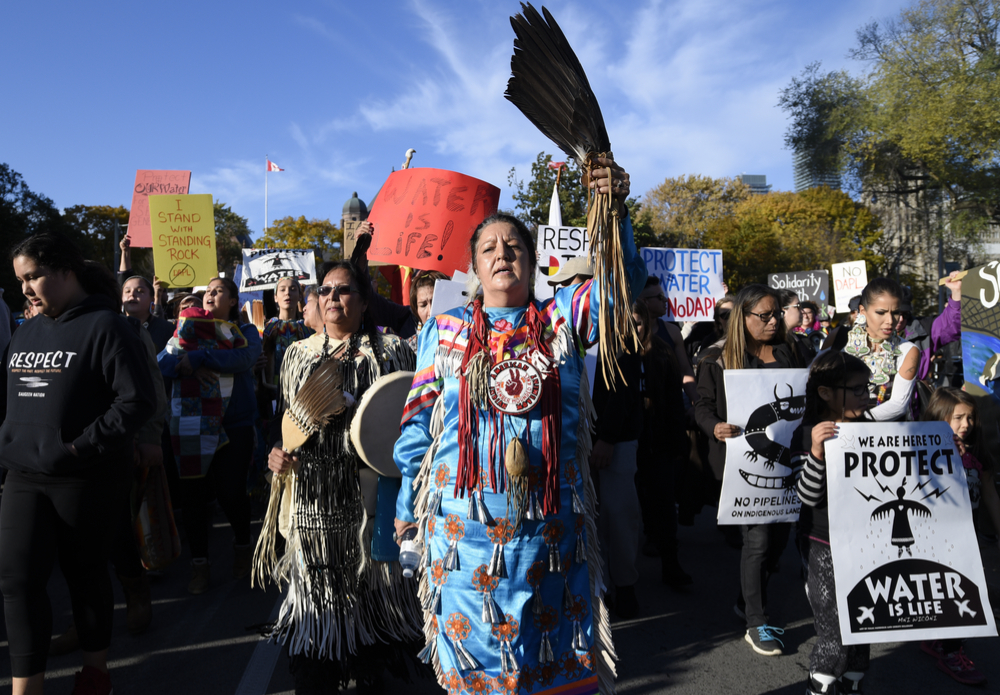 An indigenous community member leading a march during a solidarity rally
