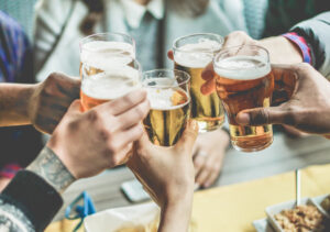 A group of friends toasting with glasses of beer