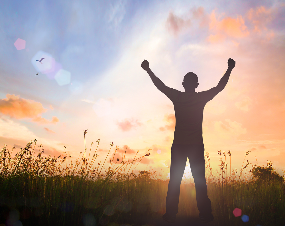 Triumphant man at sunset