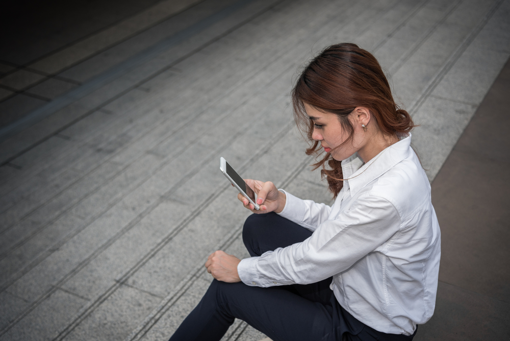 serious woman looking at phone