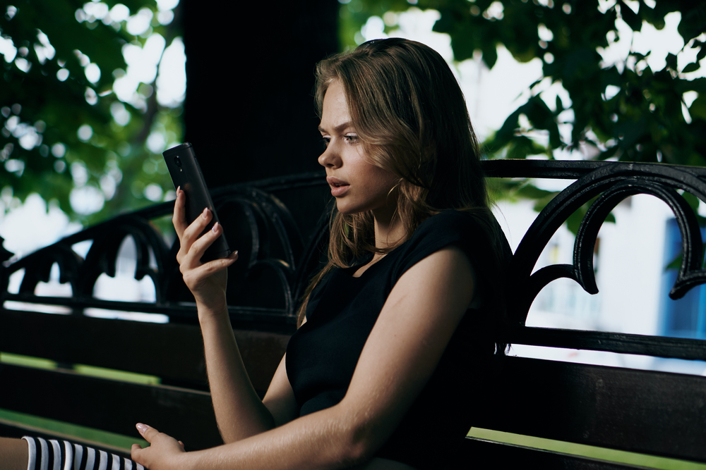 concerned woman looking at phone