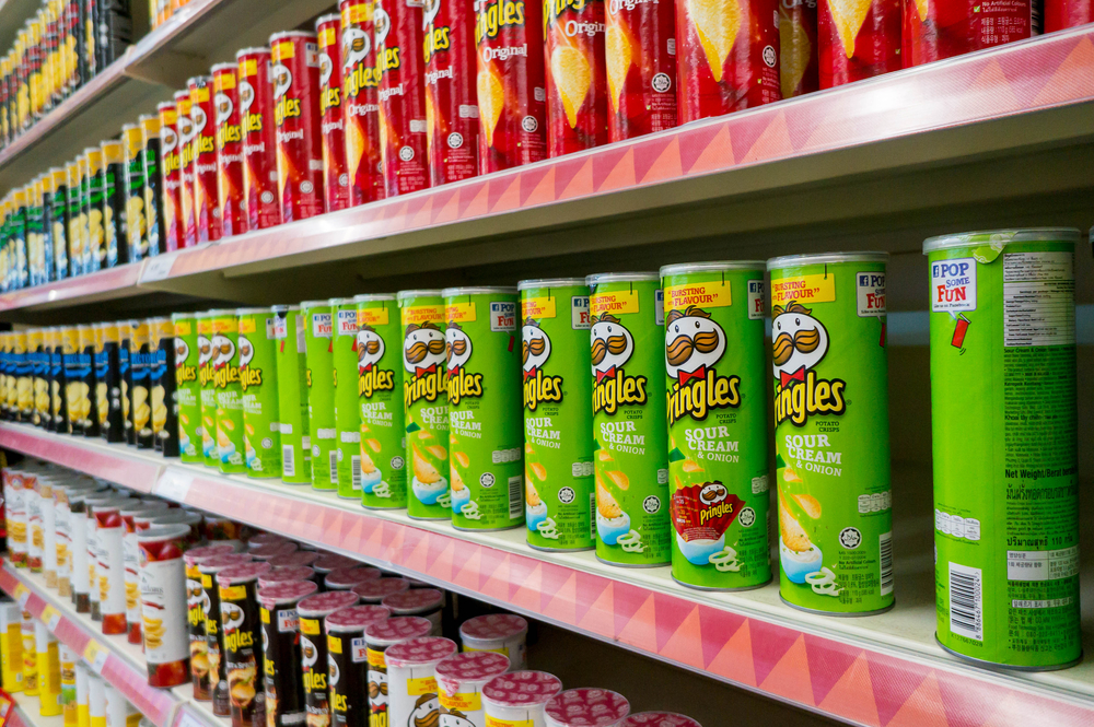 a row of pringles in a  grocery aisle.