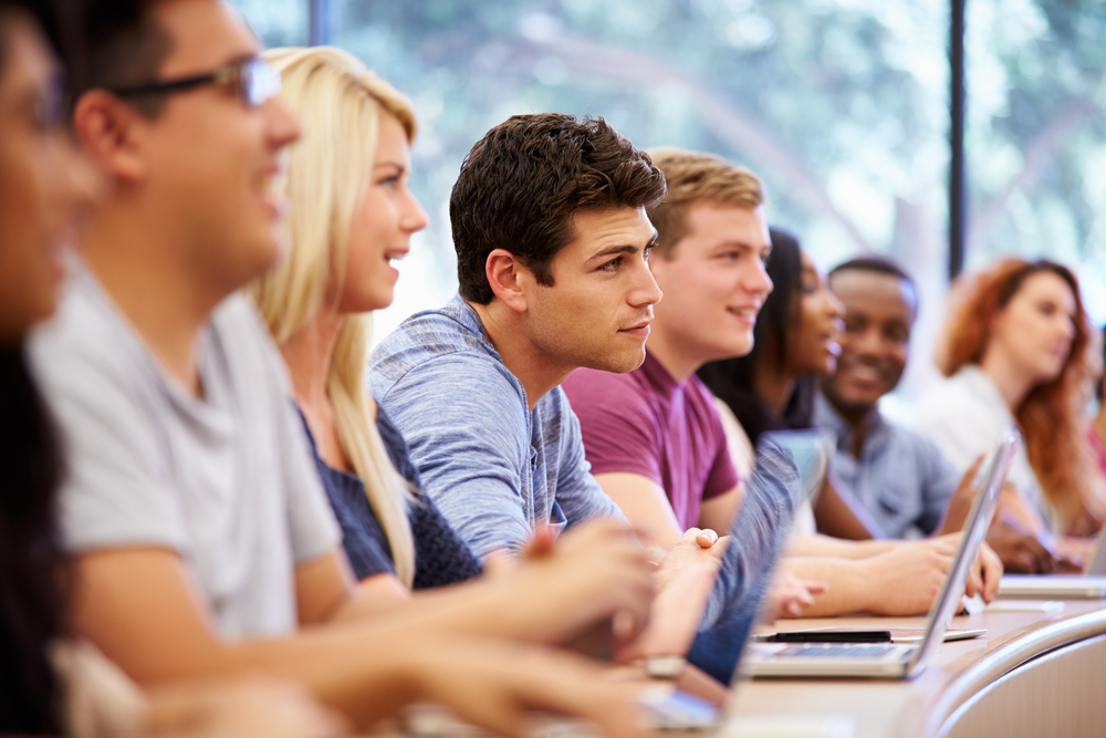 college students sitting in a classroom.