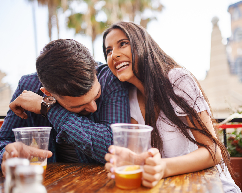 a man and a woman drinking a beer.