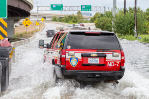 Houston emergency services with cars across the flooded street in Houston, Texas, US