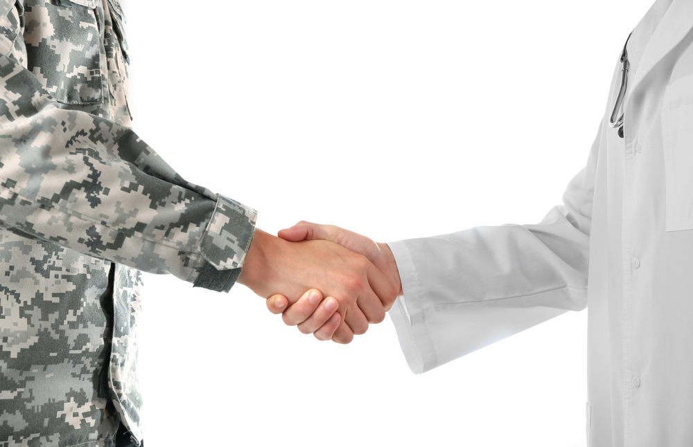 Soldier and doctor shaking hands isolated on white background