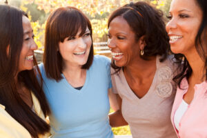 a group of women hanging out and laughing.