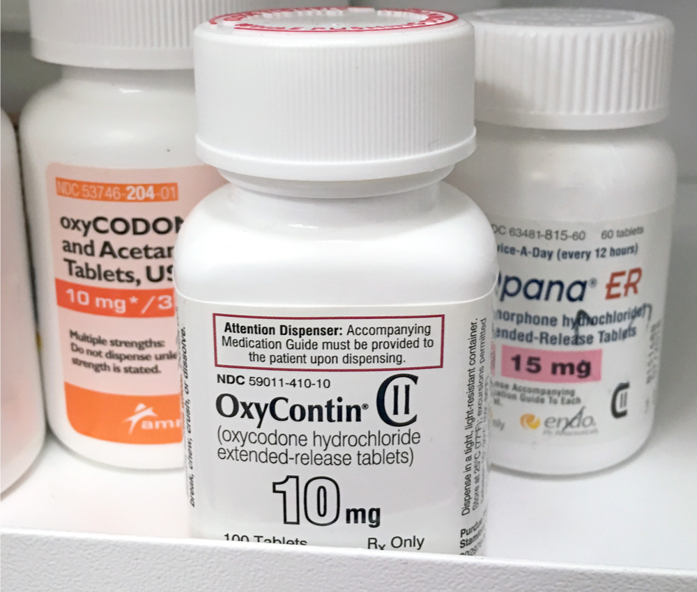 oxycontin sitting on the shelf in a pharmacy.