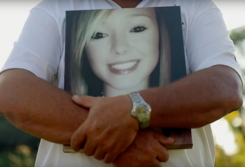 Kevin Simmers holding a picture of his daughter Brooke