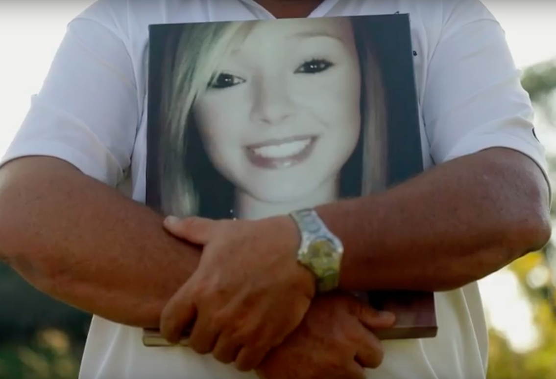 Kevin Simmers holding a picture of his daughter Brooke