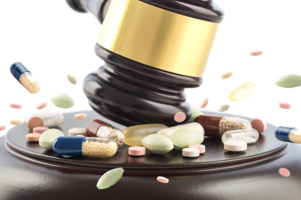 Judge's gavel smashes drug pills.