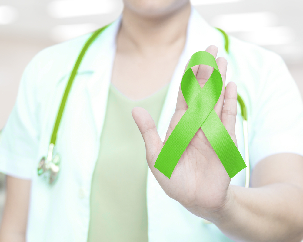 women wearing green ribbon for mental illness awareness