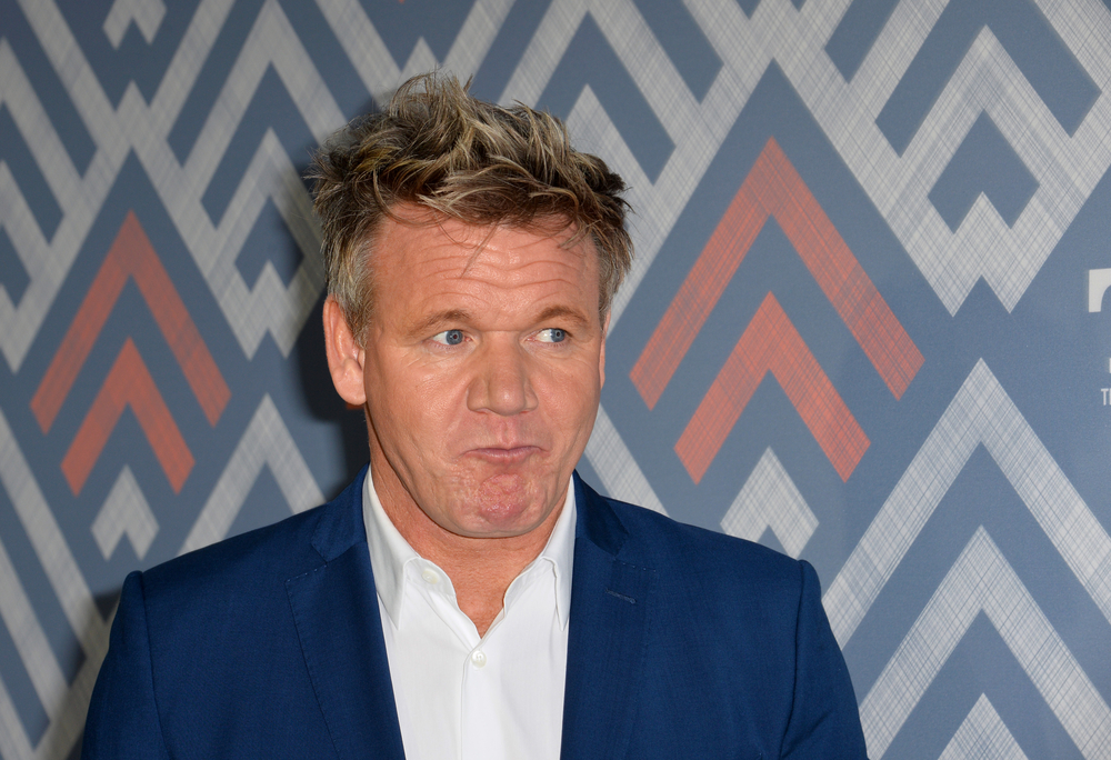 Gordon Ramsay in a blue suit looking in anticipation.