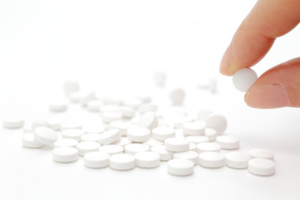 Female hand holding pill