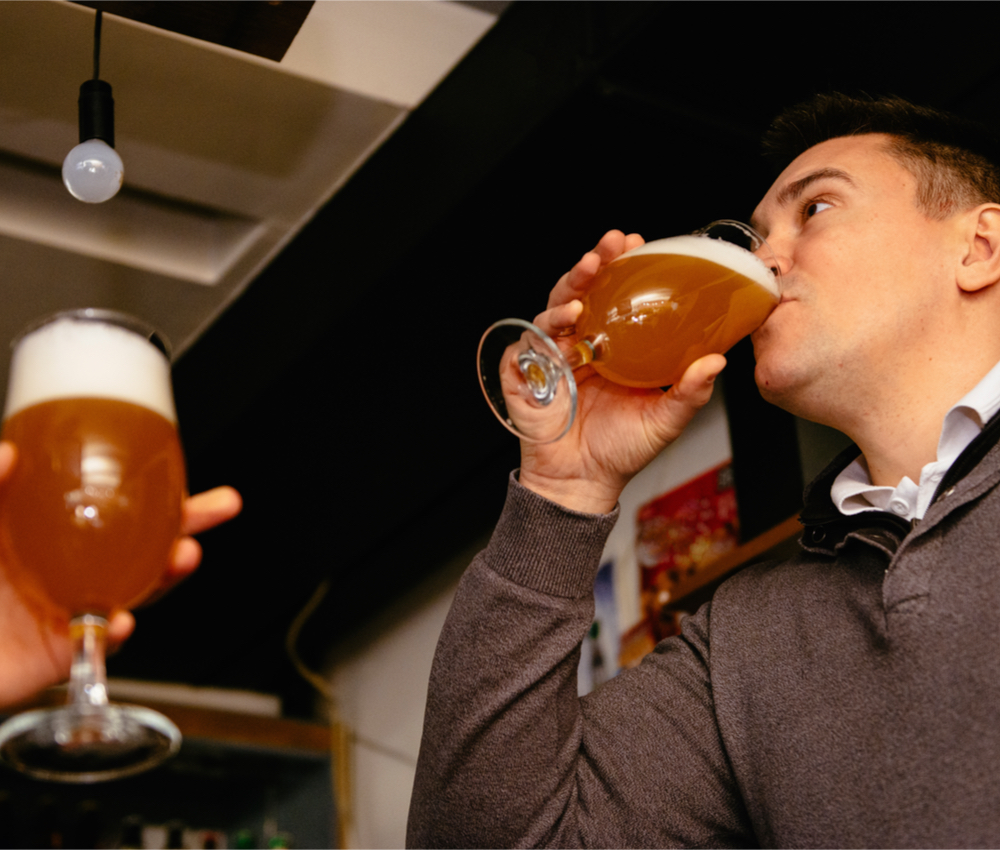 man binge drinking beer in pub
