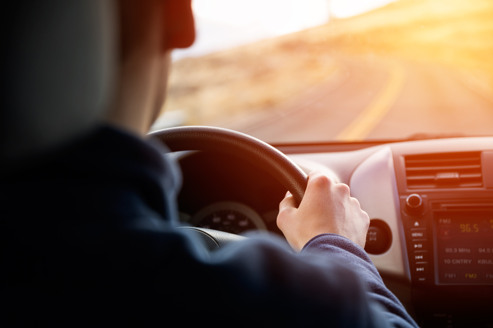 young man driving a car