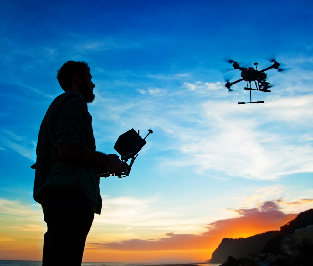 man flying a drone outside