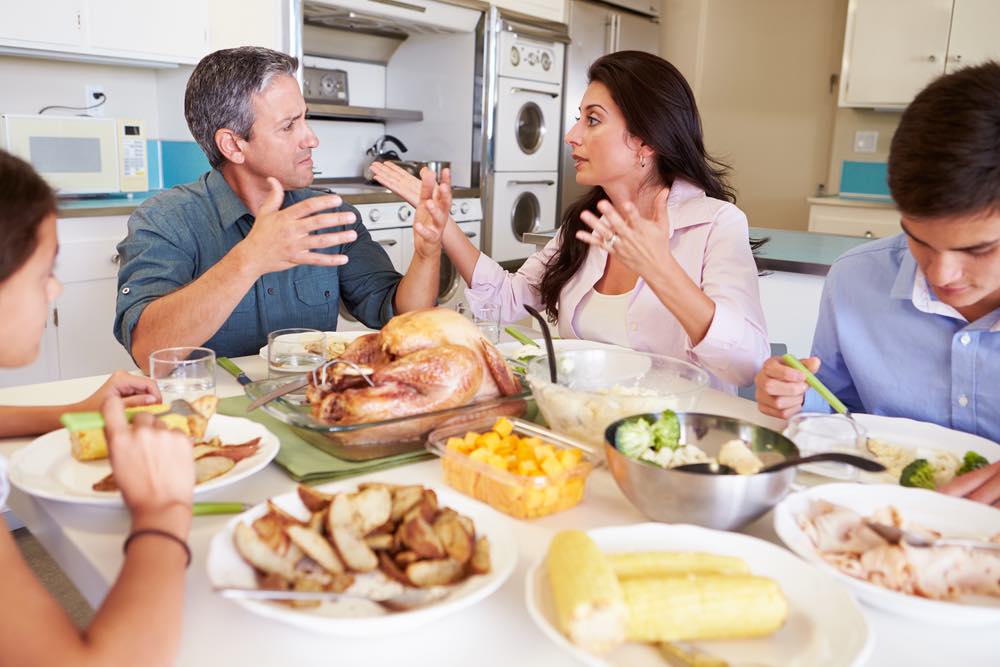 A family arguing around the dinner table.