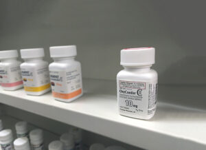 Oxycontin bottle on shelf in the pharmacy. Oxycontin is known in the news to be a cause of pain killer overdose and addiction