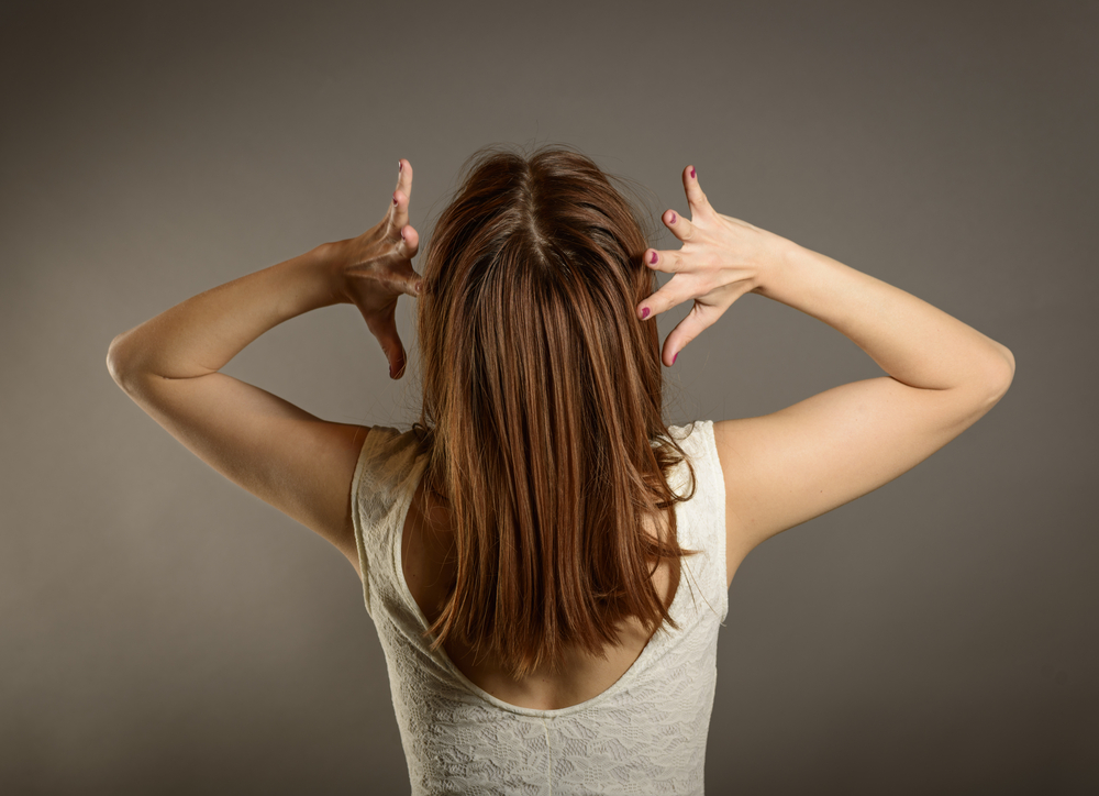 frustrated woman holding her hands to her head