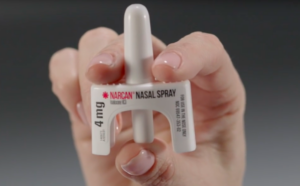 woman holding Narcan nasal spray