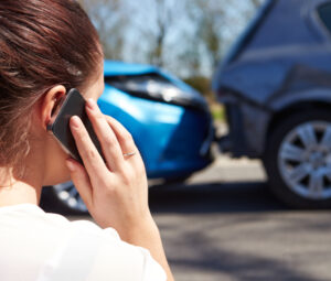 Stressed Driver Sitting At Roadside After Traffic Accident