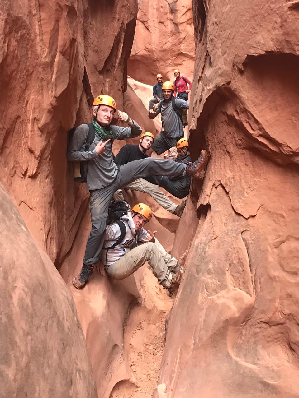 A group of men rock climbing.