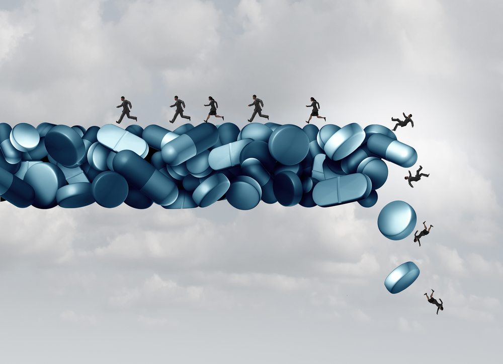 a group of people running away from a falling bridge of pills