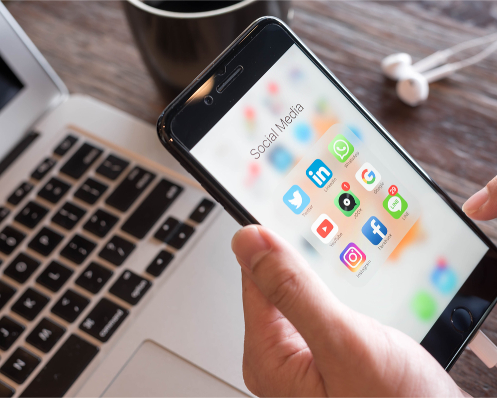 person navigating social media apps on an iPhone