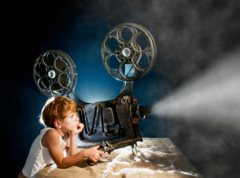 boy with a film projector