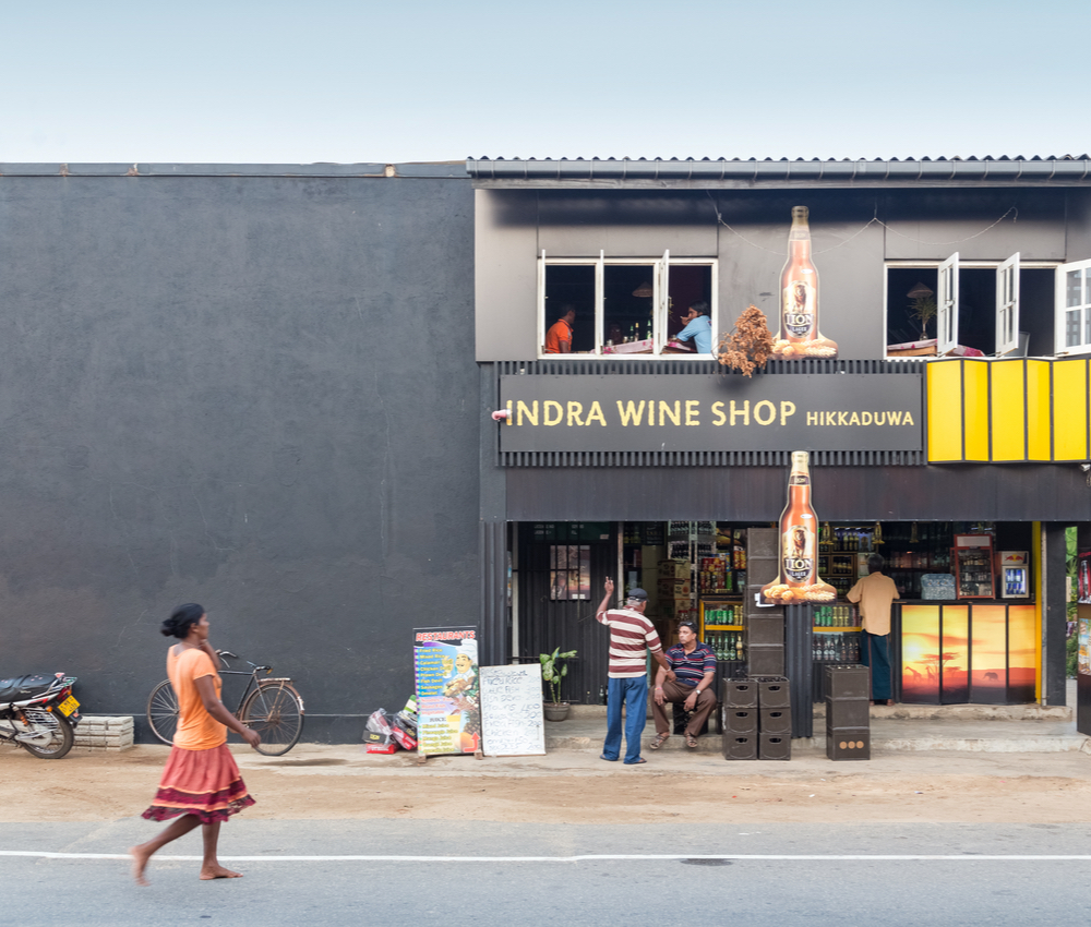 Sri Lankans standing in front of the Indra Wine Shop.