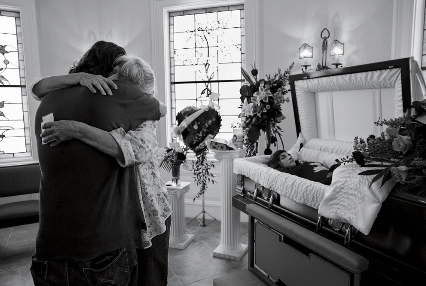 Cheryl Schmidtchen being consoled at the funeral for her granddaughter Michaela Gingras in Manchester, N.H.,