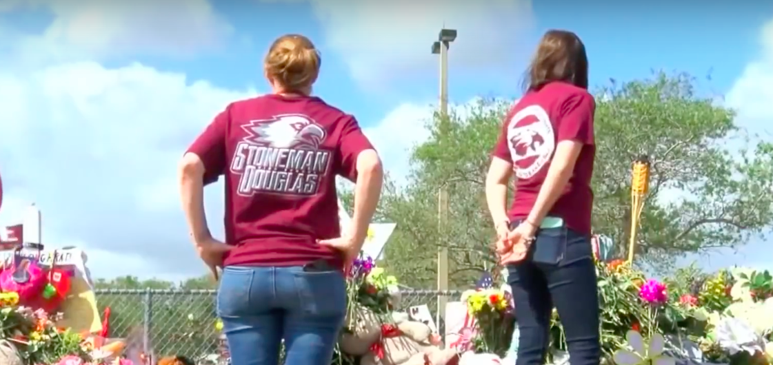 Marjory Douglas students standing near a memorial