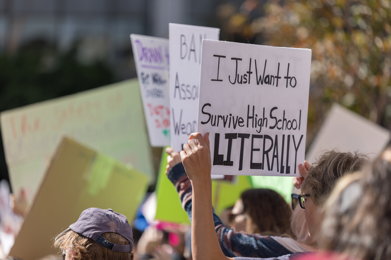 someone holds `I just want to survive High School LITERALLY` sign at the People`s Rally Against Gun Violence.