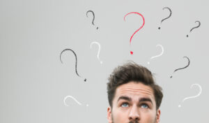 thinking man with many question marks above his head