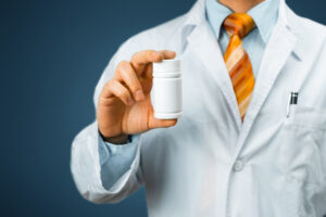 doctor holding a bottle of pills