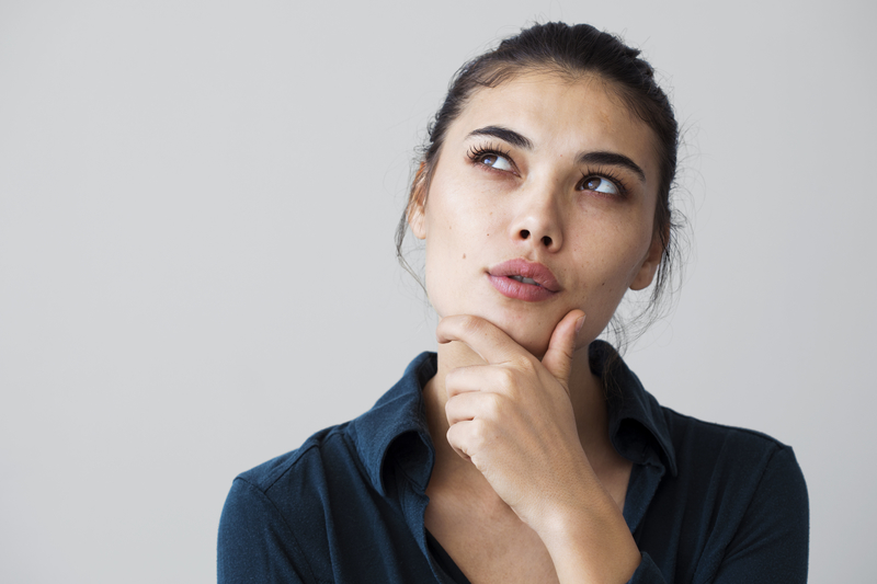 A woman in a thinking pose, hand on chin
