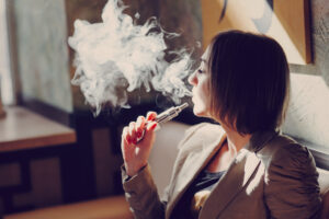 a woman smoking an electronic cigarette