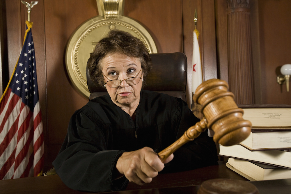 serious female judge with gavel in hand