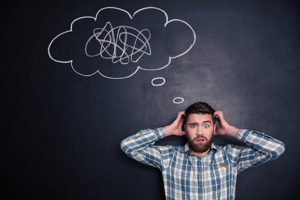 confused man with his hands on his head