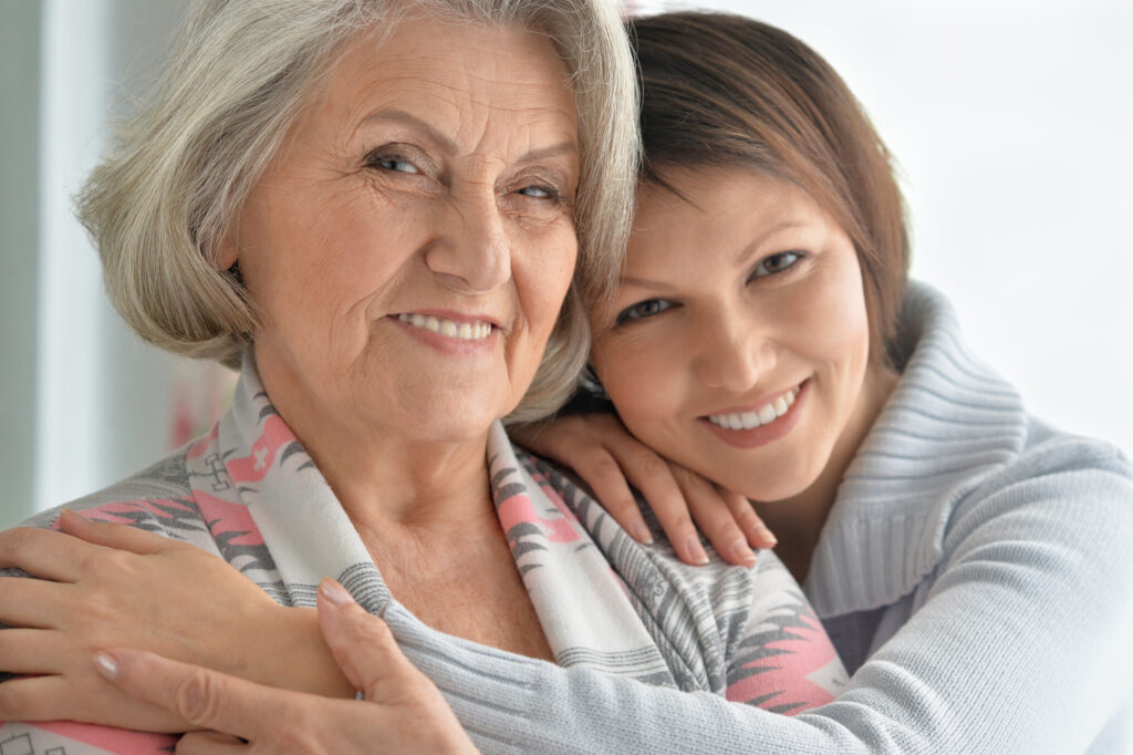 Cheerful senior mother and adult daughter together
