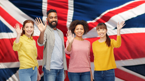 A group of young people in front of the British flag.