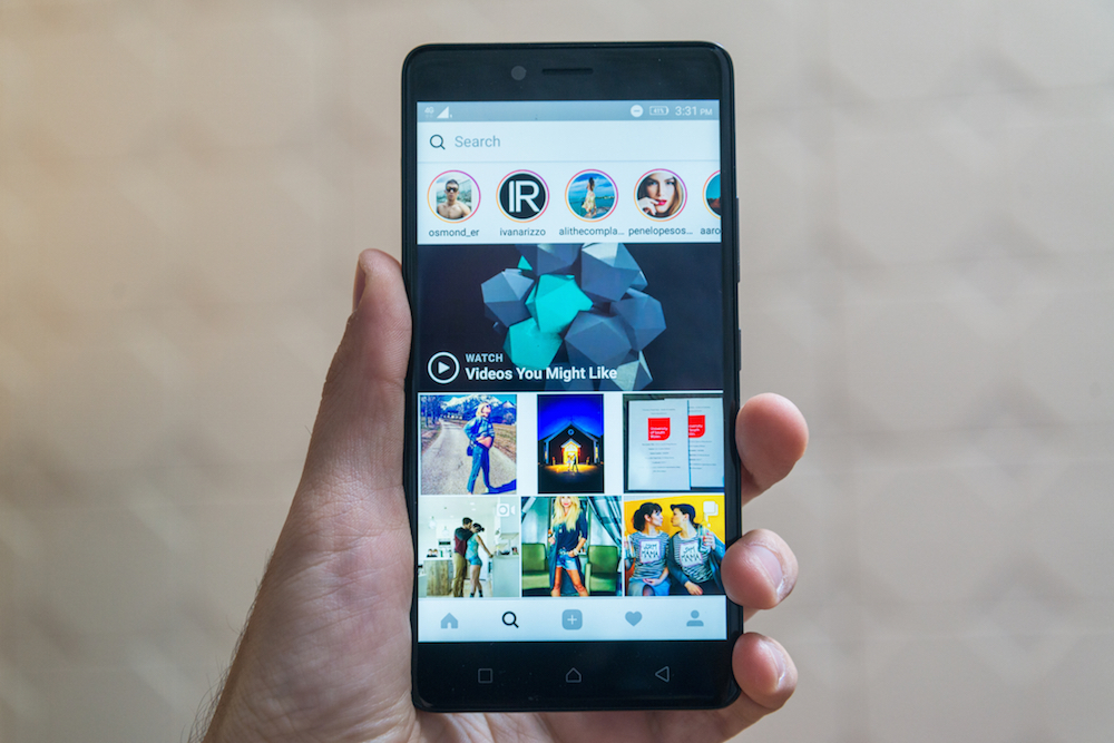 person holding a phone opened to Instagram app