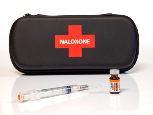A case with "Naloxone" label, vial, and syringe.
