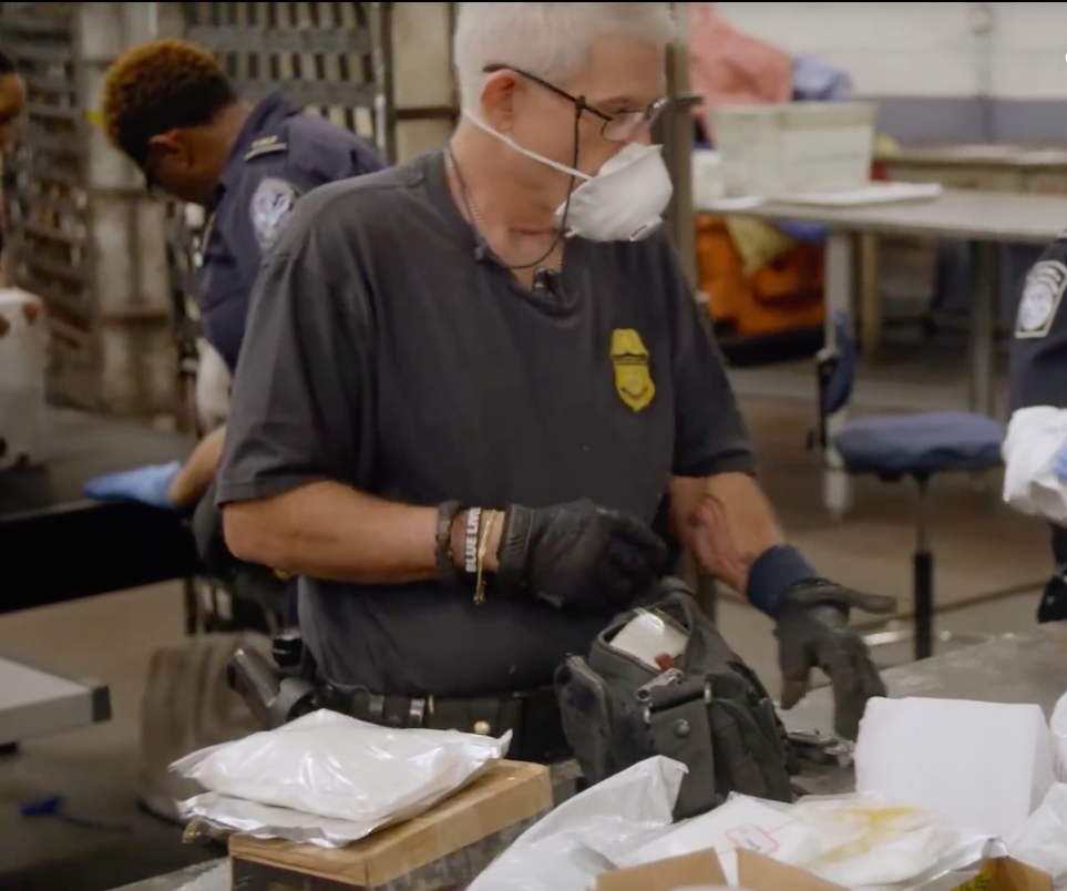 DEA agent sorting through confiscated fentanyl