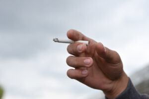 hand holding a lit cigarette
