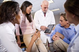 students listening to a professor in a lab coat